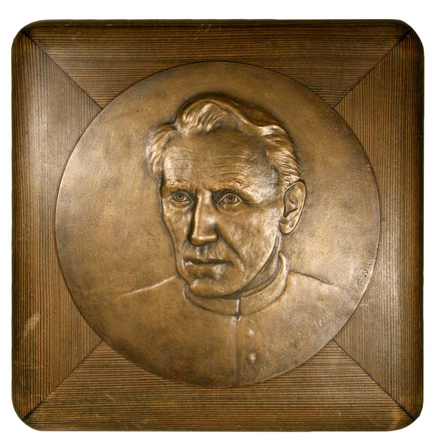 BOVET, Joseph / WILLI, E. (Artist Sculpteur): - Plaque commmorative en bronze (en rond ca. 25X25 CM.) avec le portrait en relief de l'abb Joseph Bovet (vers 1930), mont sur support en bois.